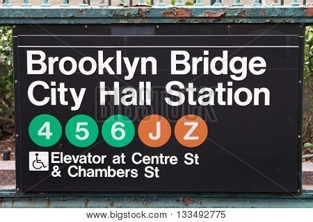 NEW YORK CITY - CIRCA 2016: Brooklyn Bridge City Hall subway station sign hangs above the underground entrance in lower Manhattan, New York City in 2016. The NYC subway system provides access to Manhattan, Queens, Brooklyn, the Bronx, and Staten Island.