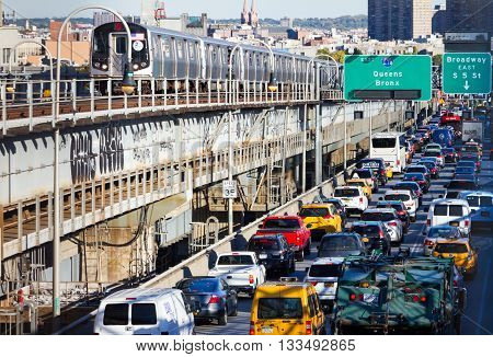 NEW YORK CITY - OCTOBER 15: Heavy traffic back ups on the Williamsburg Bridge while a subway train passes by during rush hour in New York City on October 15 2015. The bridge connects Lower Manhattan with the borough of Brooklyn.
