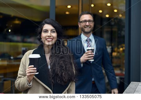 Two Business Colleagues Purchasing Takeaway Coffee