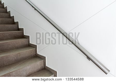 Stairway with metallic banister in a new modern building. Every building is required to have emergency stairways as safety measure.