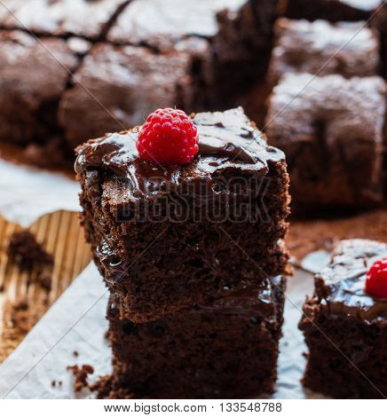 Homemade chocolate brownies with raspberry on the wooden background