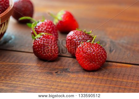 Very Beautiful Background With Fresh Strawberries In A Wicker Round Osier Basket On Old Brown Wooden