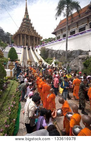 SARABURI ,THAILAND -JULY 7, 2009  : Many Unidentified People Give Flowers to Buddhist Monks for alms in The Tak Bat Dok Mai (give flowers to monk) Ceremony at Phrabuddhabat Woramahavihan Temple on July 7,2009 in Saraburi,Thailand.