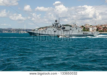 ISTANBUL TURKEY - JUNE 8 2016: The new Russian Navy frigate Admiral Grigorovich sailing rapidly along the Bosphorus past the famous Maiden's Tower at Uskudar in Istanbul Turkey. The warship is part of Russia's Black Sea Fleet.