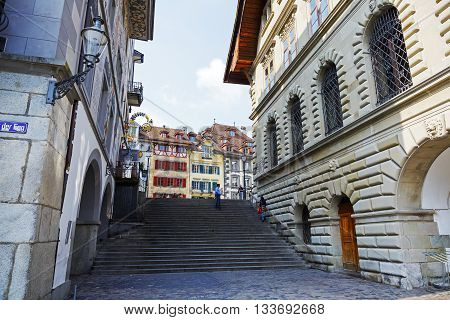 LUCERNE SWITZERLAND - MAY 02 2016: View towards colorful buildings at the square in the old town. This square is called Kornmarkt and offers variety of sightseeing attractions