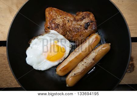 Homemade foods - Chicken fillet grilled steak and egg fried on wooden background