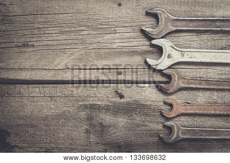 old rusty screw keys on the wooden table