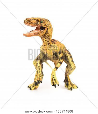 front view yellow velociraptor toy on a white background