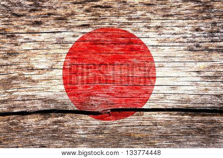 Japan flag painted on the old cracked wood with worn-out paint. Grunge look.