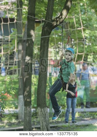 Rostov-on-Don Russia- May 29 2016: Boy trains in rope park 