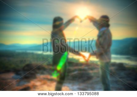 Abstract Blurred and soft photo of the lover standing on the hilltop during sunrise.