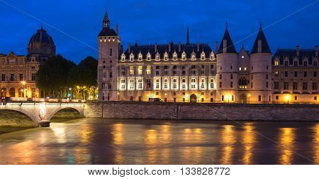 Night view of La Conciergerie (old medieval jailhouse) and the Seine river Paris France