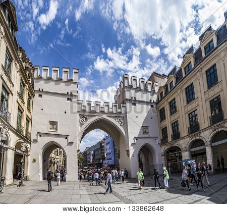 People Walking Along Through The Karlstor Gate In Munich