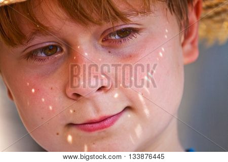 Young Boy With Straw Hat Is Happy And Smiles