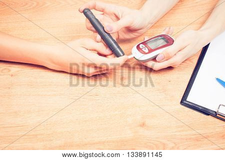 Measure child glucose level blood test diabetes little boy using glucometer