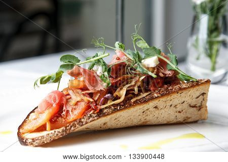 Delicious Cabbage appetizer with bacon on sour-sweet bread