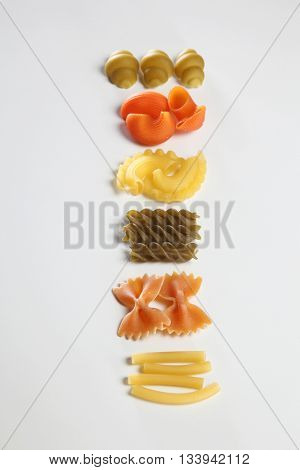 various dry pasta on the white background