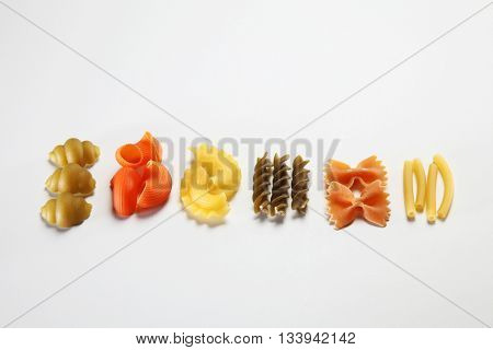 various dry pasta on the white background