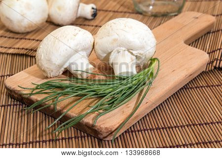 Mushrooms on a cutting board with salsola soda next