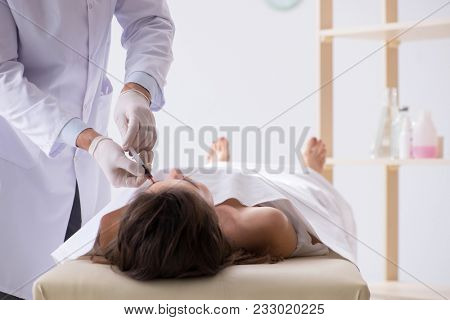 Police coroner examining dead body corpse in morgue