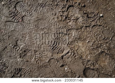 Wet Ground With Footprints. Mud Ground With Human Footprints. Soil Background