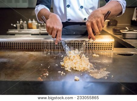 Hand Of Chef Cooking Garlic Fried Rice On Hot Pan In Front Of Customers.