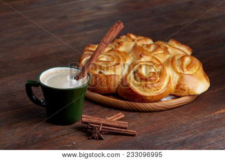 Homemade Rose Bread With Raisins On Wooden Tray, Cup Of Creamy Coffee, Anise And Cinnamon Over Vinta