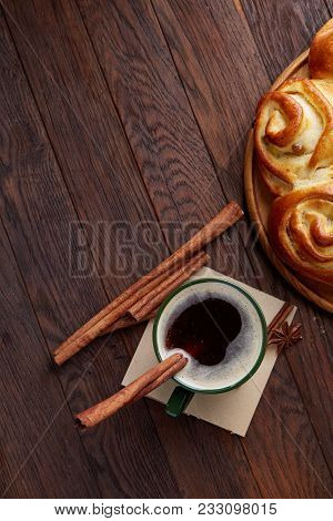 Homemade Rose Bread With Raisins On Wooden Tray, Cup Of Creamy Coffee, Anise And Cinnamon Over Vinta