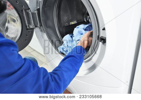Man doing laundry in laundromat