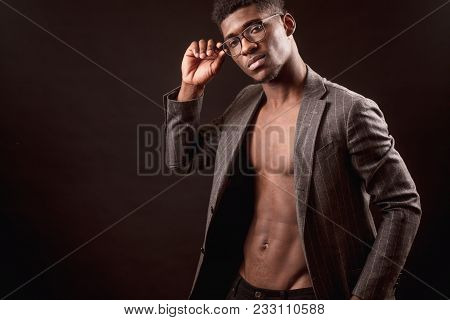 Close Up Cropped Photo Of Handsome Unshaven Afro American Man With Jacket On His Nacked Body Is Touc