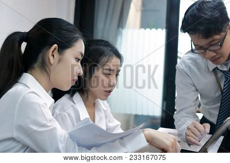 Group Of Young Asian Business People Working Together On A Laptop Computer At Office. Teamwork Brain