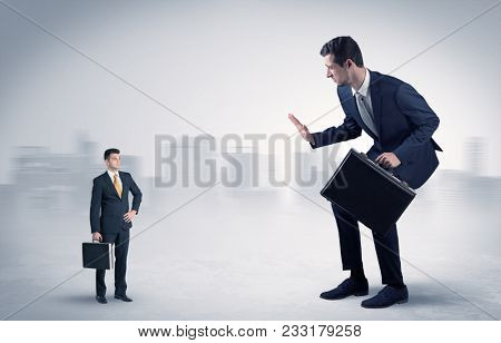 Giant businessman being afraid of small serious executor with suitcase