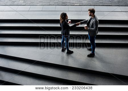 Business partners having take away coffee