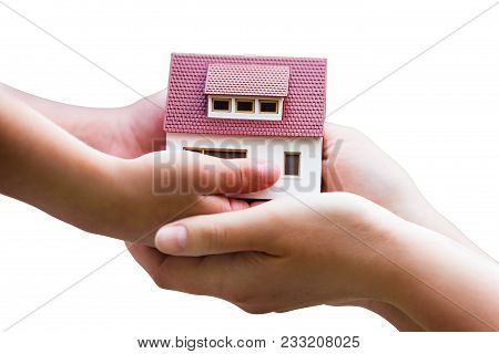 Miniature House In Chlid And Adult Hands Isolated On White