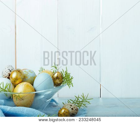 Easter Background With Easter Blue And Gold Eggs, Pussy-willow And Spring Flowers. Top View, Flat La
