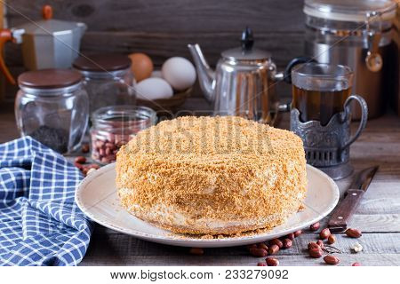 Homemade Honey Cake With Sour Cream On A Wooden Table