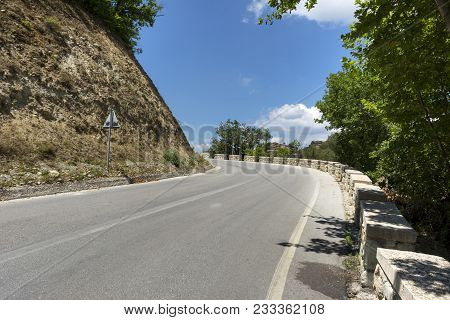 Paved Road In The Mountains Among The Greenery, Blue Sky, Road In Greece, Trees Growing On The Sidel