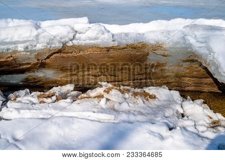 Blocks Of Ice Melt In The Spring On The Shore Of The Pond