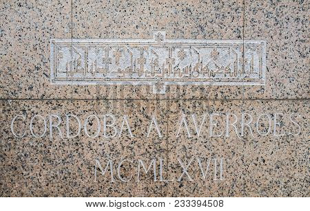 Cordoba, Spain - Dec 31, 2017: Pedestal Inscription Over Pink Marble To Philosopher Averroes Statue,