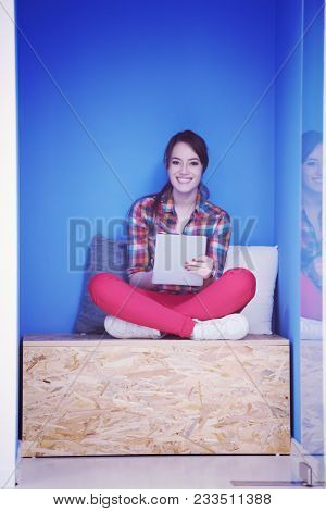 young woman in crative box working on tablet computer, startup business modern office room  interior