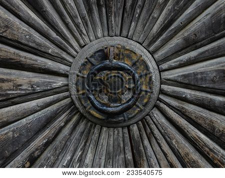 Detail Of Antique Wooden Door With Central Wrought Iron Ring Handle With Evidence Of Rust And Weathe