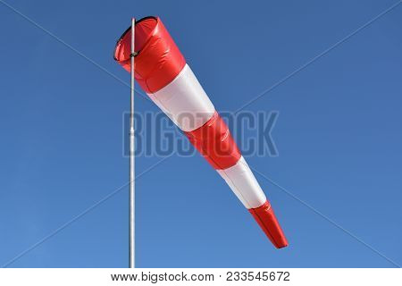 Wind Cone Against Blue Sky. Windsock In Windless And Perfect Flying Weather