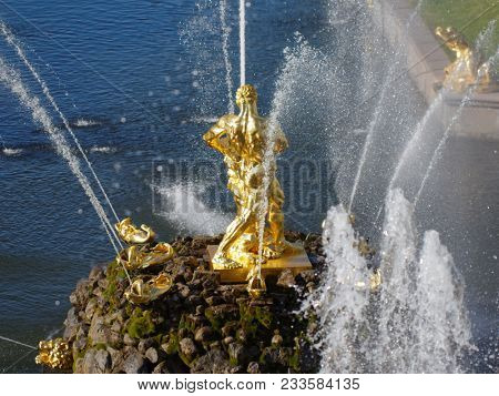 PETERHOF, ST. PETERSBURG, RUSSIA - JUNE 4, 2017: Golden statues of the Grand Cascade. The cascade was built in 1715-1724 and is one of the remarkable fountain constructions in the world