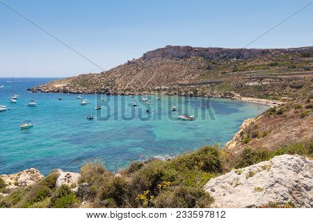 Beautiful Azure Blue Water Of Selmun Beach In The Summer Time, In Maltese Imgiebah Bay, Il-mellieha,