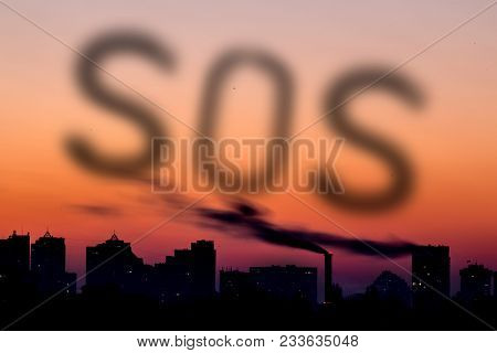 Cityscape With Dramatic Sky  Sunset. Silhouette Of Buildings And Smoking Pipes. Urban Industrial Cit