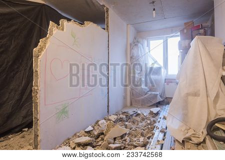 Reshaping The Apartment. Dismantling Of Walls. Things Are Covered With A Cloth For Protection From D