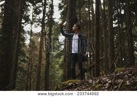Young Hipster Guy Taking Photo On His Mobile Phone Camera Of A Beautiful Landscape While Standing Ne