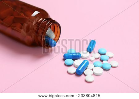 Bottle With Pills On Color Background