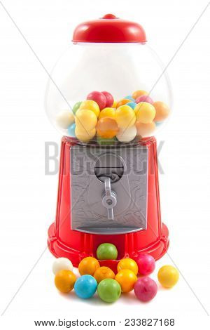 Colorful Gumballs In And In Front Of Gumball Machine Isolated Over White