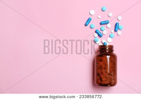 Bottle With Pills On Color Background